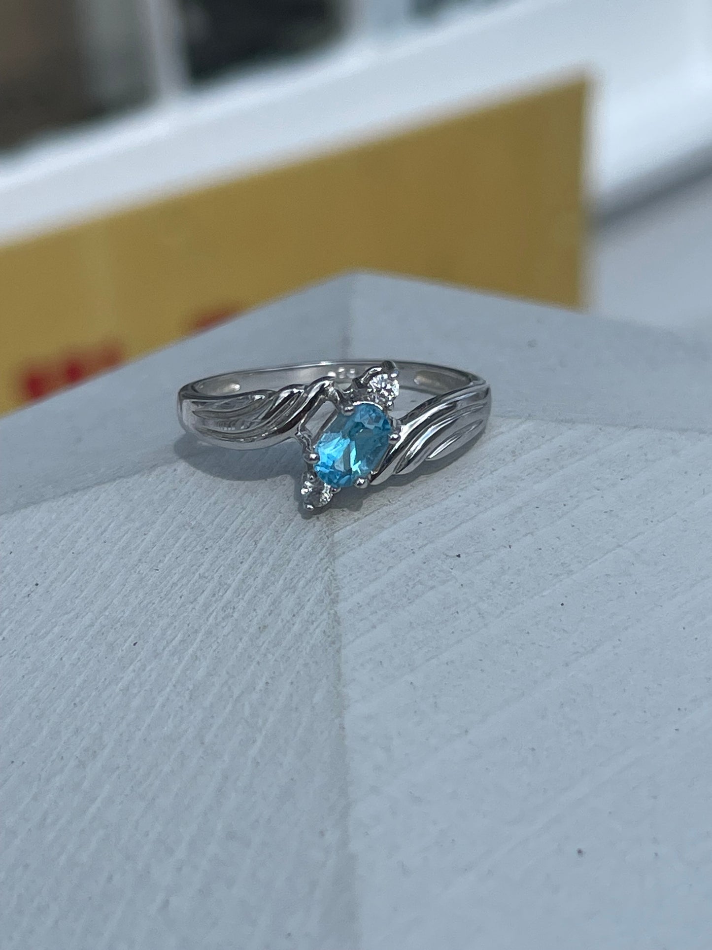 925 Sterling Silver Bypass Oval Blue Topaz & Clear Zirconia Ring