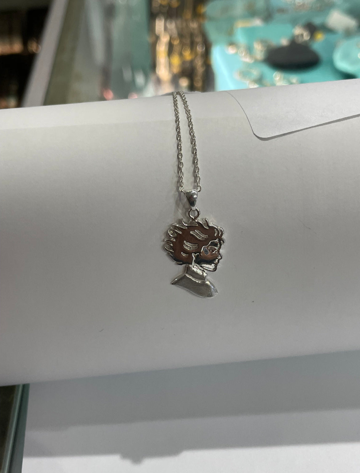 Kristin Kreuk Mad Woman’s Library Logo Necklace
