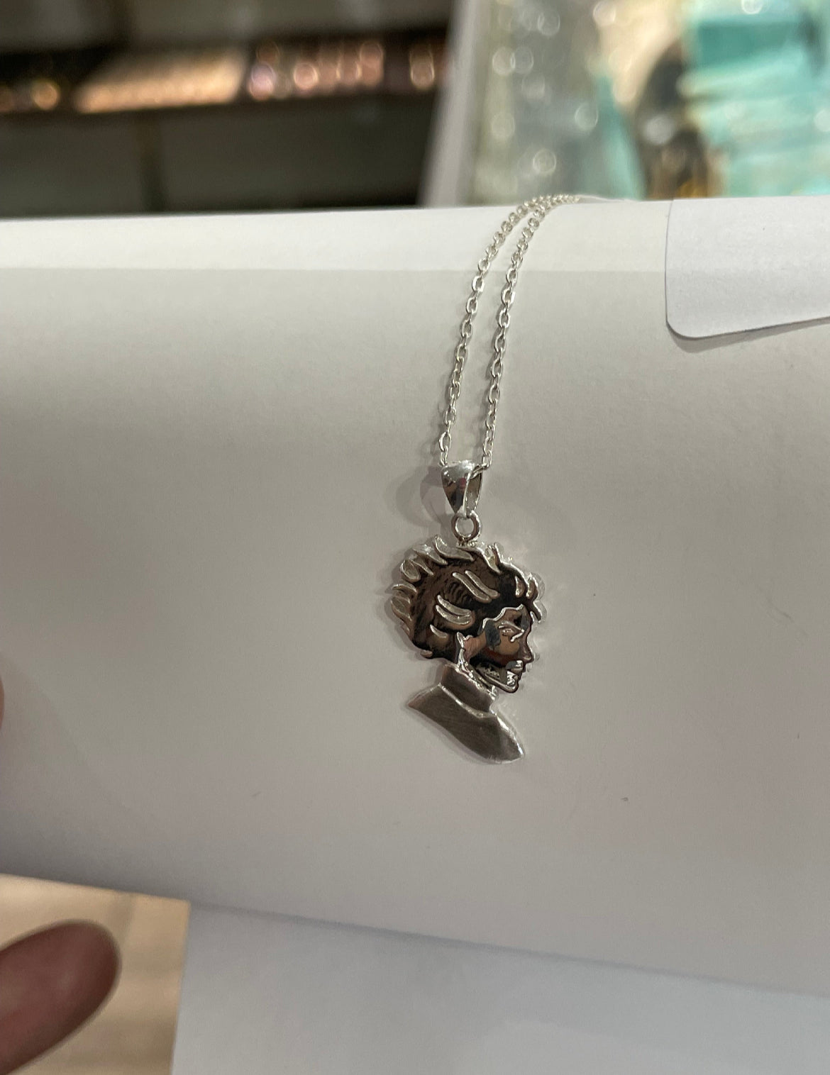 Kristin Kreuk Mad Woman’s Library Logo Necklace