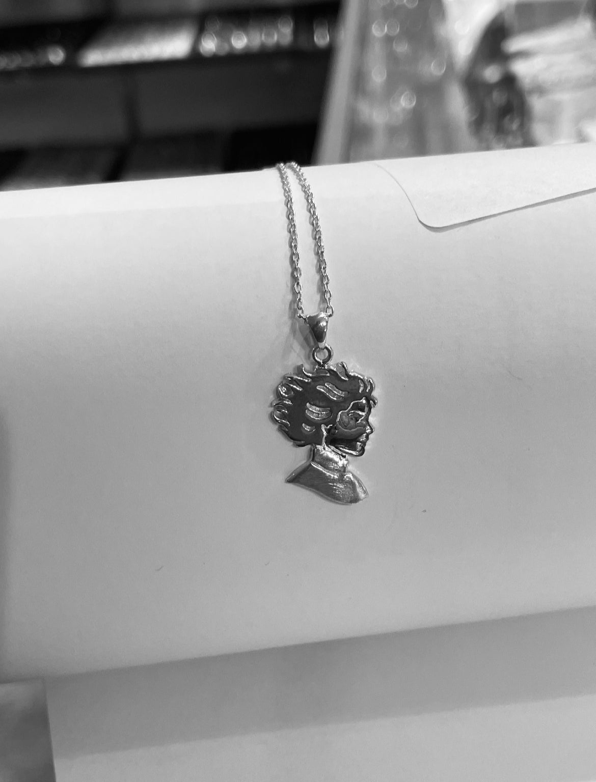Kristin Kreuk Mad Woman’s Library Logo Necklace