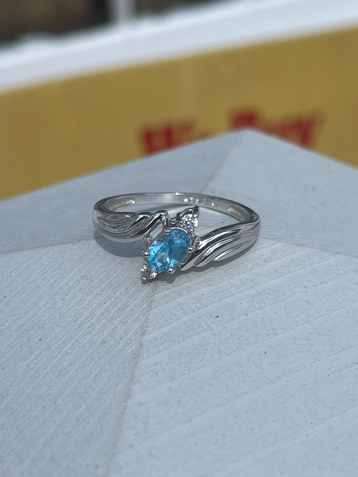 925 Sterling Silver Bypass Oval Blue Topaz & Clear Zirconia Ring